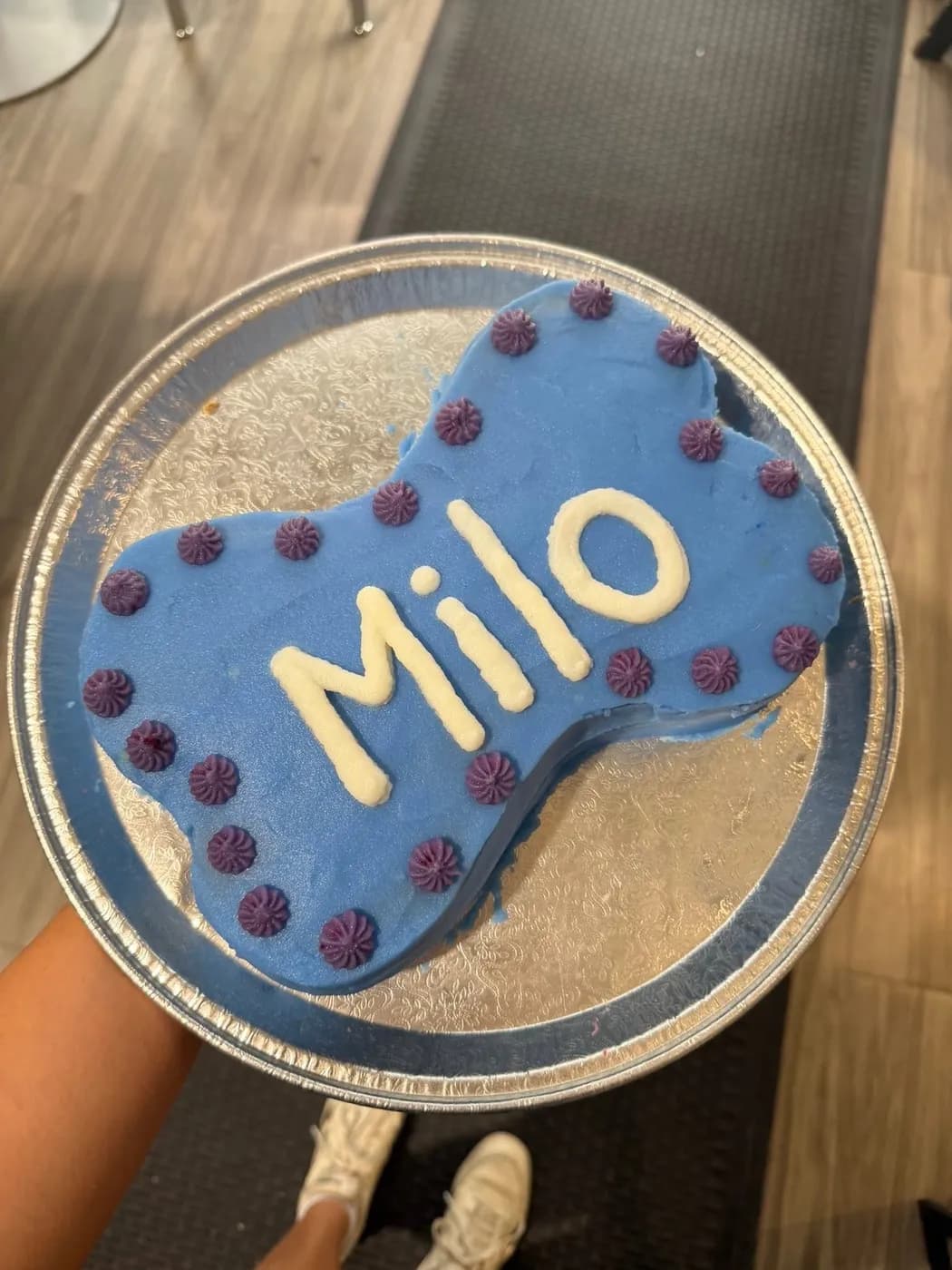 A blue and purple bone-shaped birthday cake
